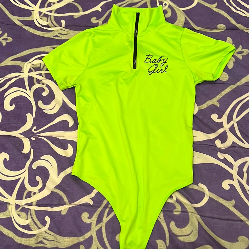 A neon green graphic body suit from fashion nova